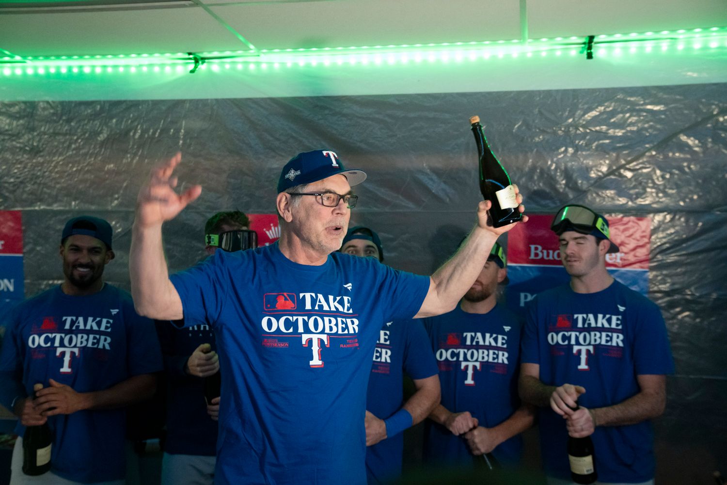Texas Rangers manager Bruce Bochy addresses his team in the clubhouse after clinching a playoff berth Saturday night at T-Mobile Park in Seattle.